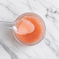 Strawberry Lip Scrub texture on a spoon — pink sugar scrub